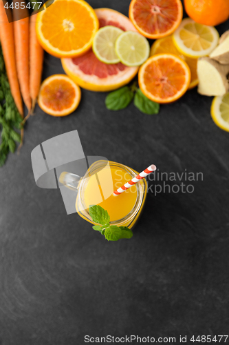 Image of mason jar glass of fruit juice on slate table top