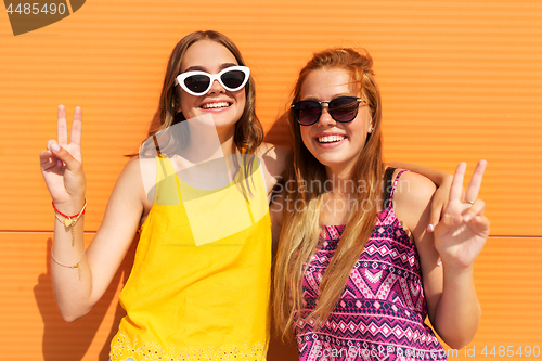 Image of smiling teenage girls showing peace in summer