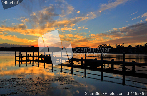 Image of Beautiful sunset and timber jetty silhouette