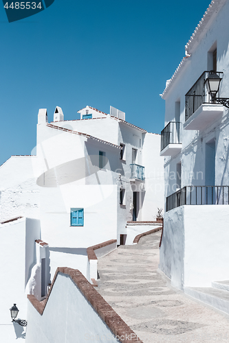 Image of Street with white houses under blue sky