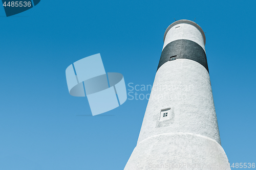 Image of White lighthouse against blue sky