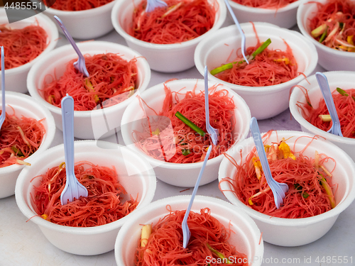 Image of Pink noodles in styrofoam bowls