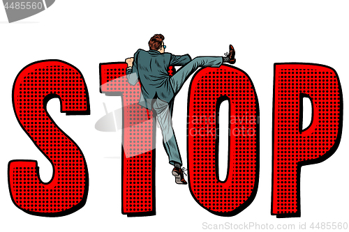 Image of businessman man climbs on the word stop