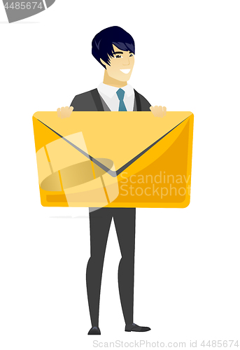 Image of Smiling groom holding a big envelope.