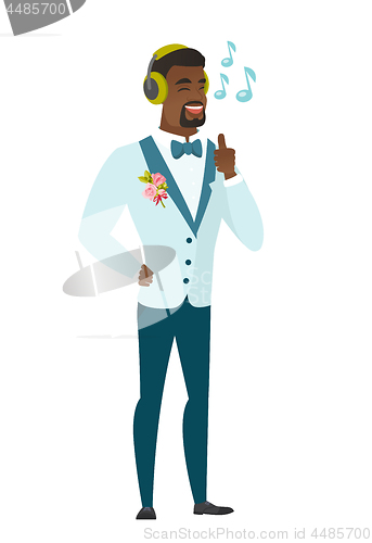 Image of Groom listening to music in headphones.