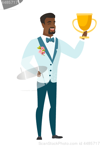 Image of African-american groom holding a trophy.