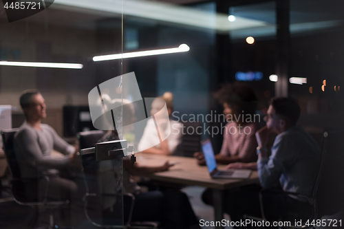 Image of Multiethnic startup business team in night office