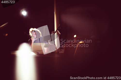 Image of man working on computer in dark office