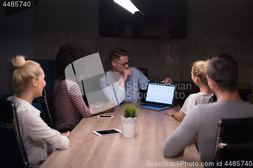 Image of Multiethnic startup business team in night office