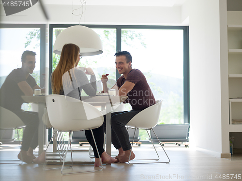 Image of couple enjoying morning coffee and strawberries