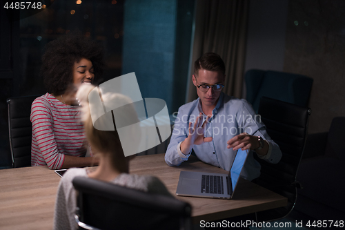 Image of Multiethnic startup business team in night office