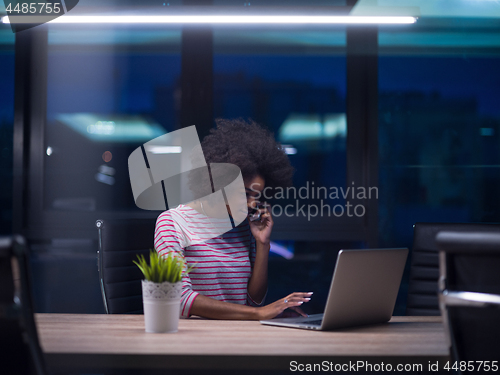 Image of black businesswoman using a laptop in startup office