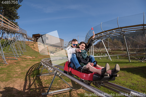 Image of couple enjoys driving on alpine coaster