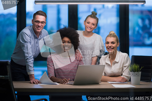 Image of Multiethnic startup business team in night office