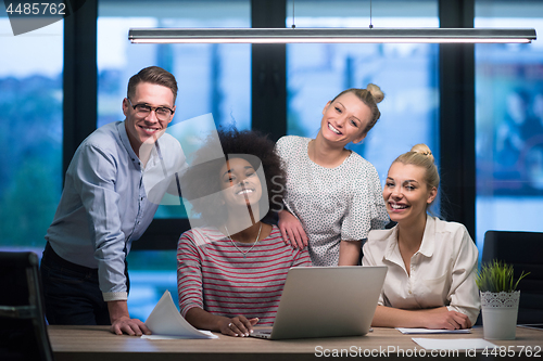 Image of Multiethnic startup business team in night office