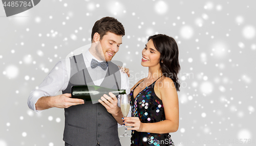 Image of happy couple with champagne celebrating christmas