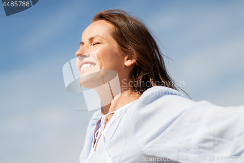 Image of happy smiling woman enjoying sun