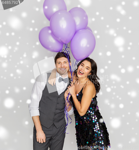 Image of happy couple with ultra violet balloons at party