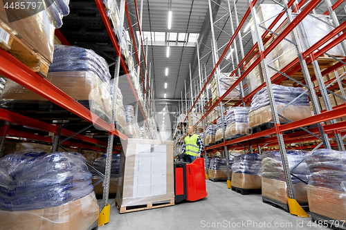 Image of loader operating forklift at warehouse