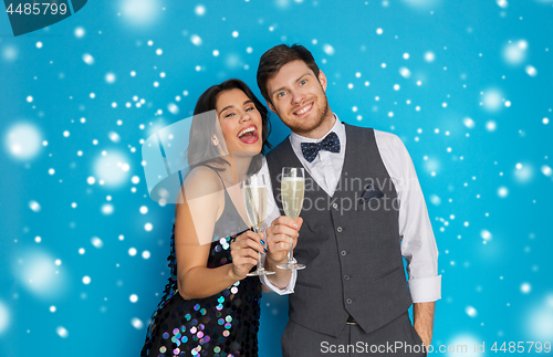 Image of happy couple with champagne celebrating christmas