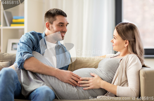 Image of happy man with pregnant woman at home