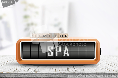 Image of Time for spa message on a colorful alarm clock