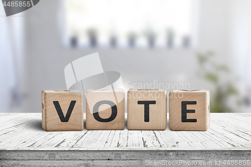 Image of Vote sign made of wood in a bright room