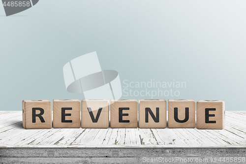 Image of Revenue sign on a wooden desk