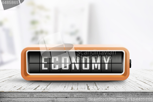 Image of Economy word on an analog device in a bright home