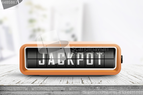 Image of Jackpot message on a retro alarm device in a bright room