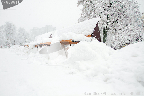 Image of Park with Bench covered with Snow