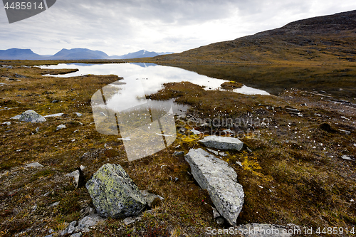 Image of Lake and stones in autumn mountains. Northern Sweden