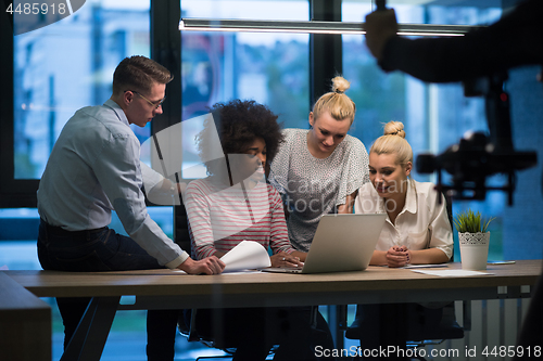 Image of Multiethnic startup business team in night office