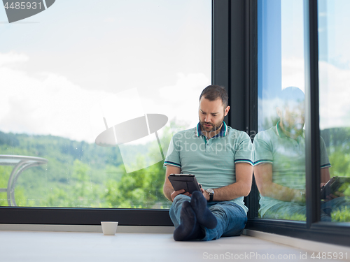Image of man on the floor enjoying relaxing lifestyle