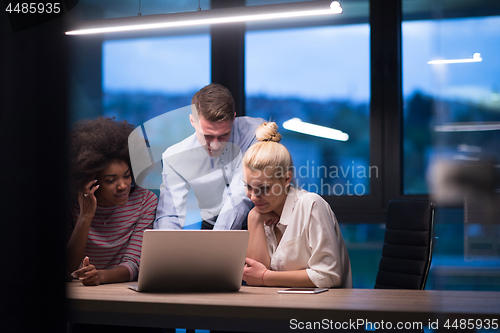 Image of Multiethnic startup business team in night office