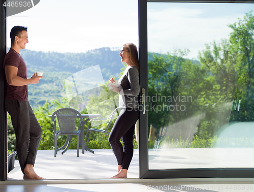 Image of couple on the door of their luxury home villa