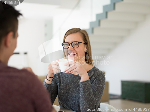 Image of couple enjoying morning coffee and strawberries