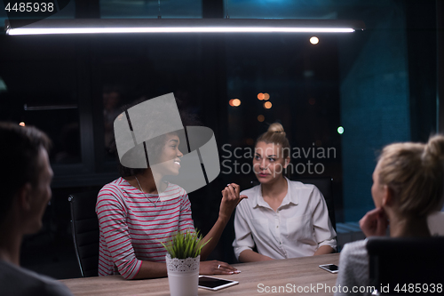 Image of Multiethnic startup business team in night office