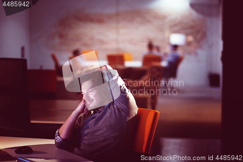 Image of businessman relaxing at the desk