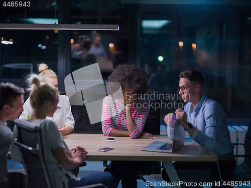 Image of Multiethnic startup business team in night office