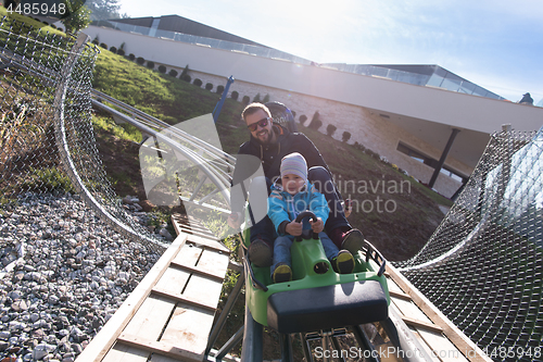 Image of father and son enjoys driving on alpine coaster