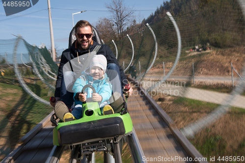 Image of father and son enjoys driving on alpine coaster