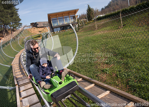 Image of father and son enjoys driving on alpine coaster