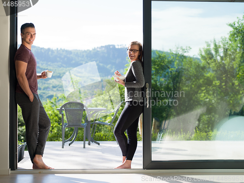 Image of couple on the door of their luxury home villa