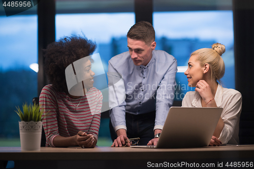 Image of Multiethnic startup business team in night office