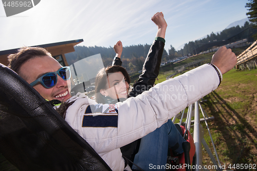 Image of couple enjoys driving on alpine coaster