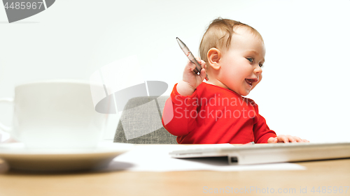 Image of Happy child baby girl toddler sitting with keyboard of computer isolated on a white background