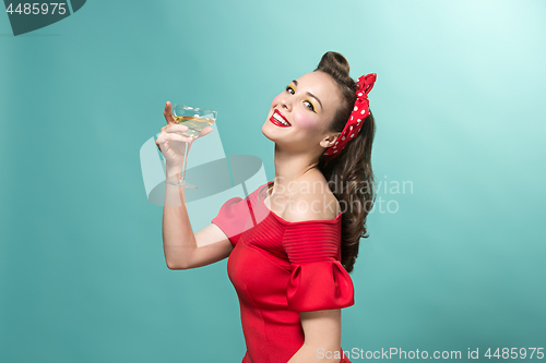 Image of Beautiful young woman with pinup make-up and hairstyle. Studio shot on white background