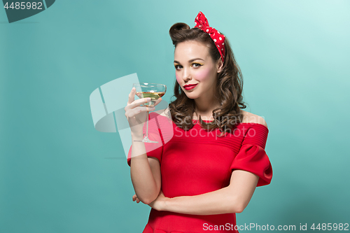 Image of Beautiful young woman with pinup make-up and hairstyle. Studio shot on white background