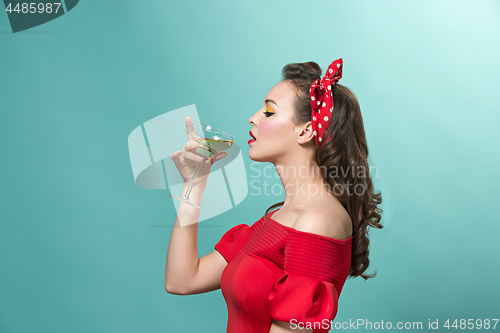 Image of Beautiful young woman with pinup make-up and hairstyle. Studio shot on white background